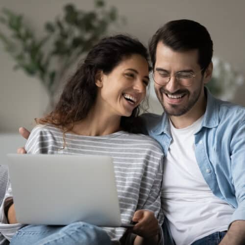 Happy millennial couple examining insurance paperwork