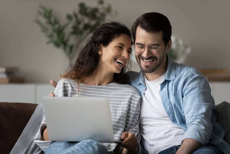 Happy millennial couple examining insurance paperwork