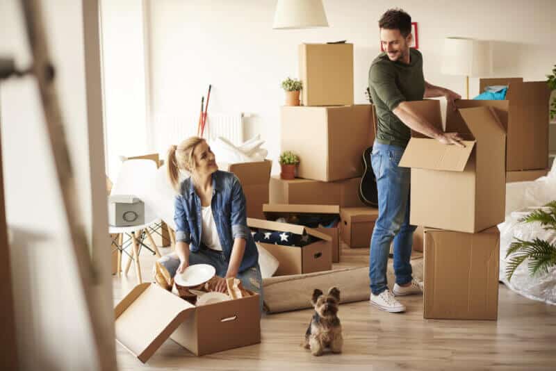young couple with moving boxes in new apartment