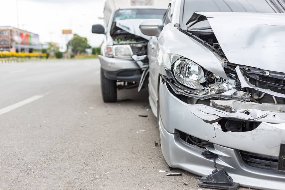 front view of a car accident with an uninsured driver with two damaged cars