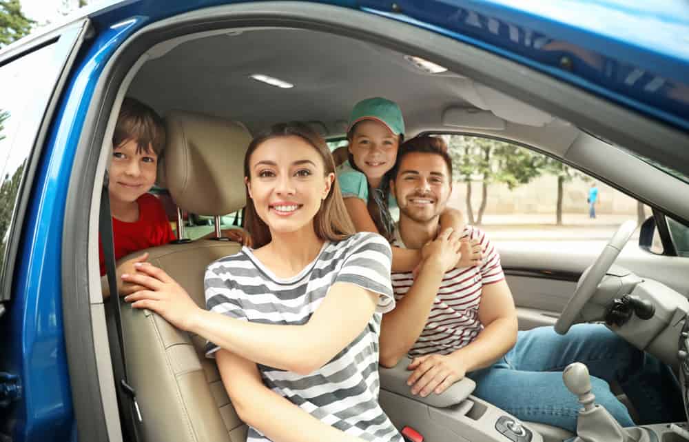 happy family traveling with children by car