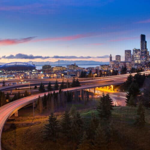 seatle landscape at dusk with skyline and freeway with cars with washington insurance