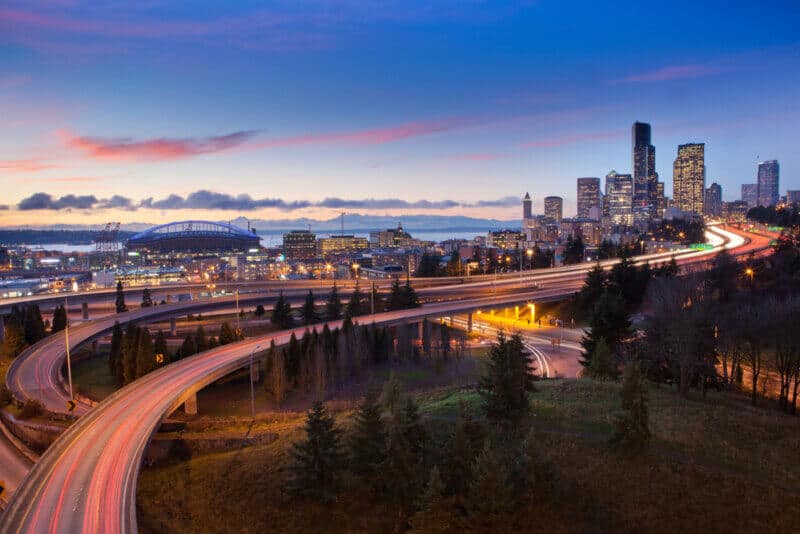 seatle landscape at dusk with skyline and freeway with cars with washington insurance