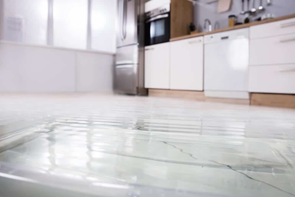close up of flooded kitchen floor in house with insurance