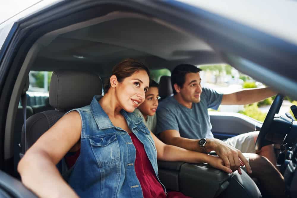 hispanic family in car with insurance