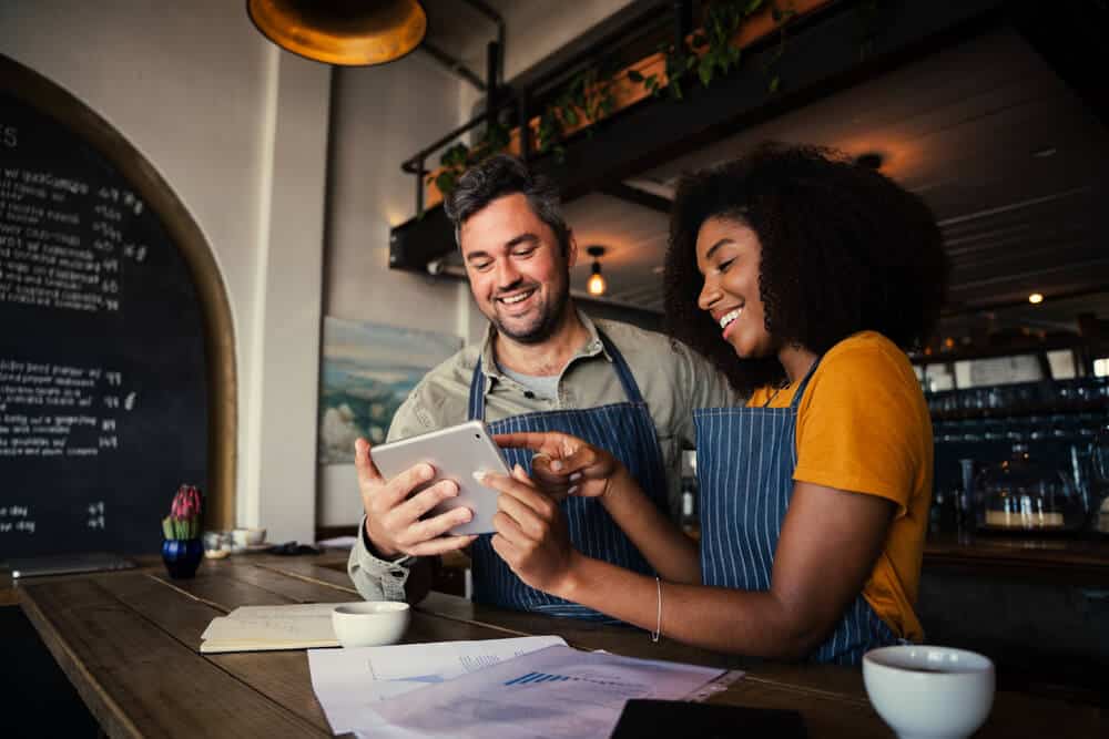 business owner in washington with employee in coffee shop with insurance