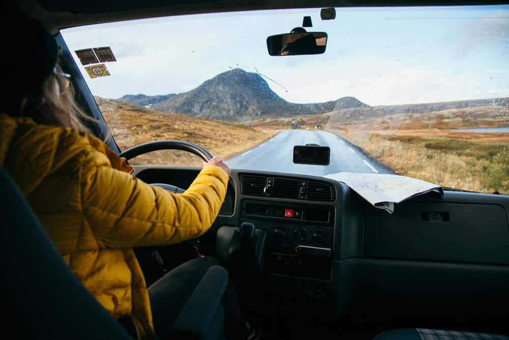 female driver at the wheel of a rv on a road