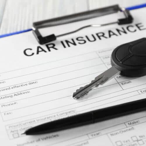 clipboard with auto insurance form and car keys