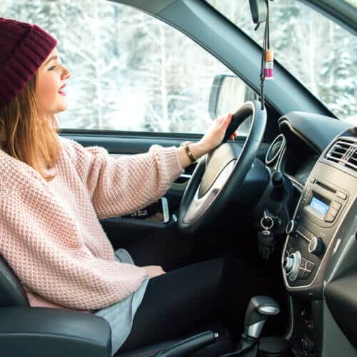 woman driving car in winter weather