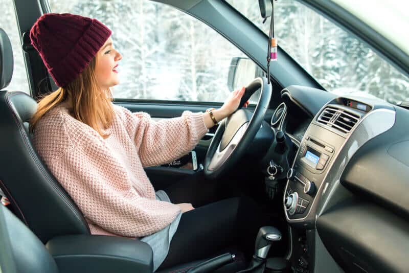 woman driving car in winter weather