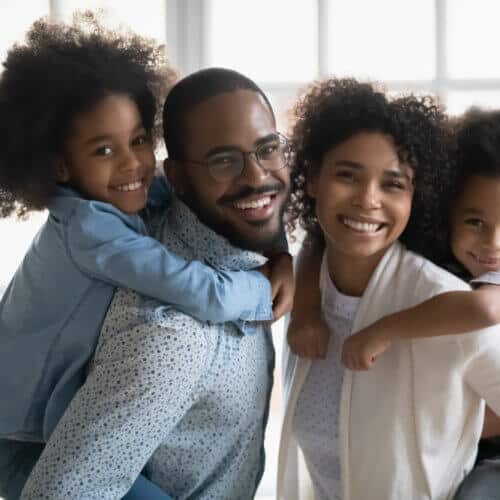 african american family with two children smiling