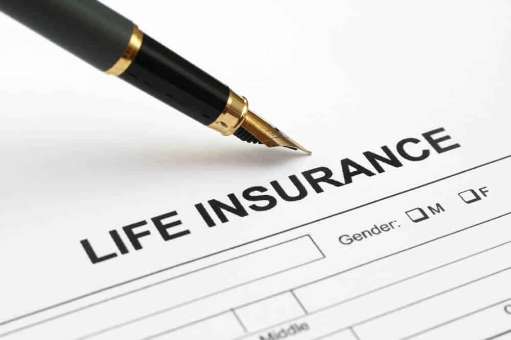 paper and pen with life insurance document