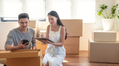 young couple going through boxes in their house