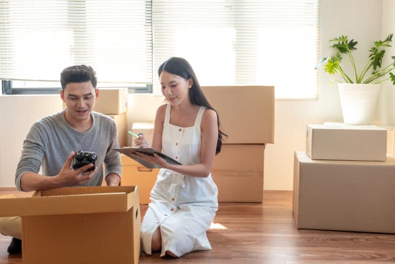 young couple going through boxes in their house