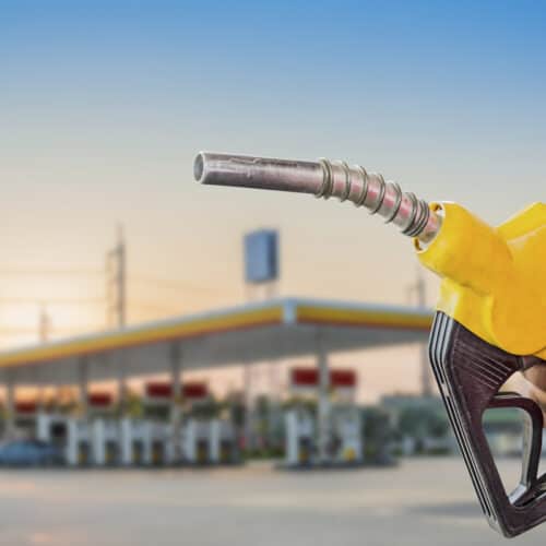 gas pump help up in front of gas station