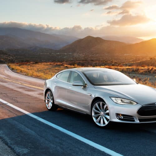 luxury car driving down highway