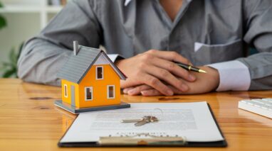 person sitting in front of home insurance paperwork