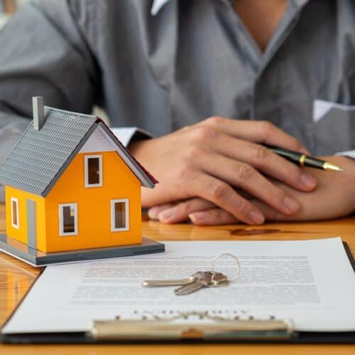 person sitting in front of home insurance paperwork