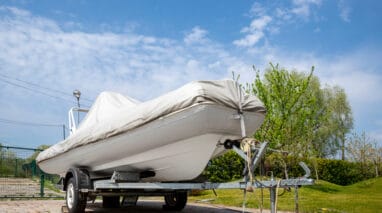 boat on trailer being stored with cover