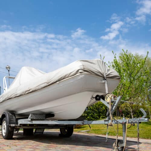 boat on trailer being stored with cover