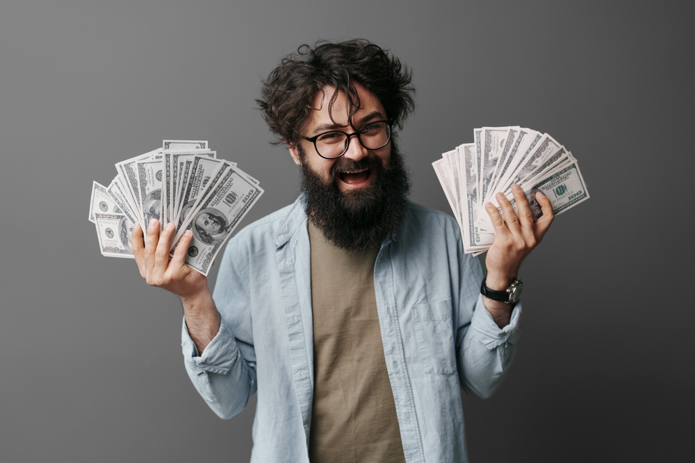 A typical Washington resident holds lots of cash, showing the amount of money it could cost if you get caught driving without insurance in Washington.