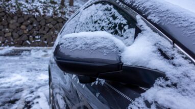 car parked in winter weather covered in snow and ice