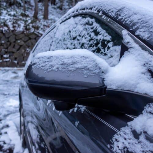 car parked in winter weather covered in snow and ice