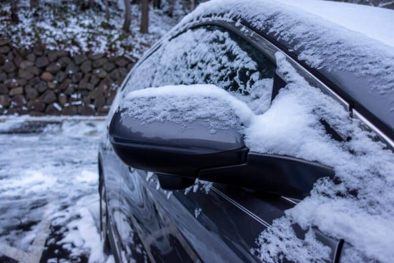 car parked in winter weather covered in snow and ice