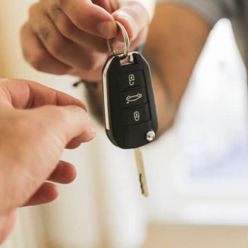 person handing over car keys