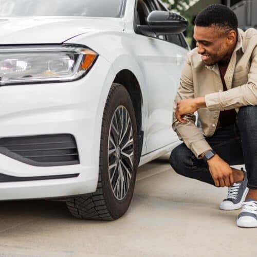 African American man checks his tires