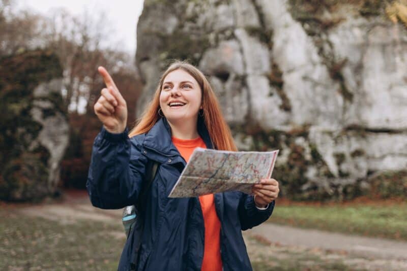 Women with red hair happily exploring on a road trip in Washington