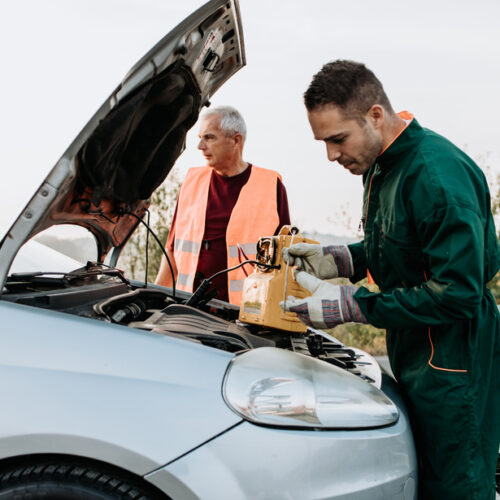 Roadside assistance technician checks battery