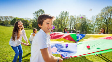 Kids playing bounce the balls at summer camp