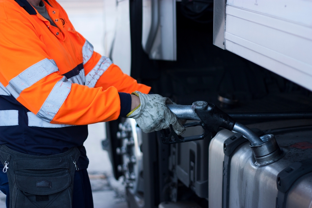 Man refuels a diesel truck