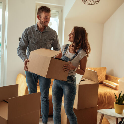 Young smiling couple moving into their new apartment in Seattle