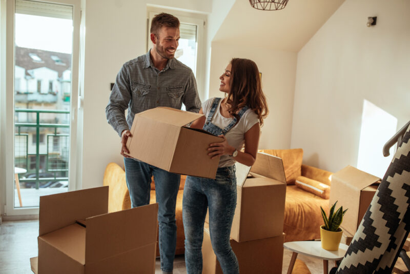 Young smiling couple moving into their new apartment in Seattle