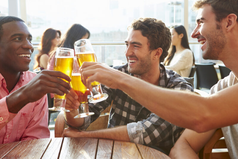 Male friends out having a beer in the bar - cheap DUI insurance in Washington