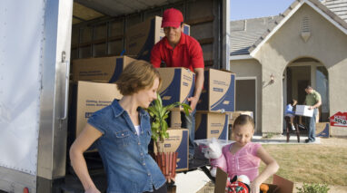 Family loading boxes and furniture in a moving truck, cheap homeowners insurance to protect your move.