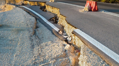 An image of a crack in the road showing an earthquake line.