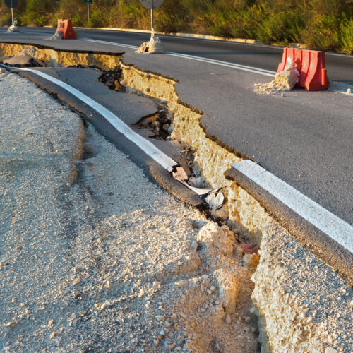 An image of a crack in the road showing an earthquake line.