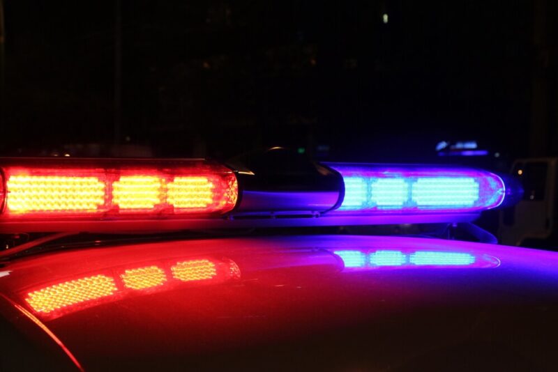 Red and blue flashing lights on top of a police car.