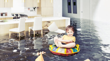 Small child floating in an inner tube through a flooded home - cheap home insurance in Washington.