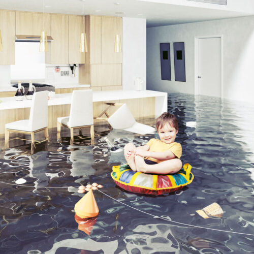 Small child floating in an inner tube through a flooded home - cheap home insurance in Washington.