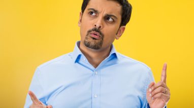 Man with yellow background trying to decide if he should switch car insurance companies - cheap car insurance in Washington.