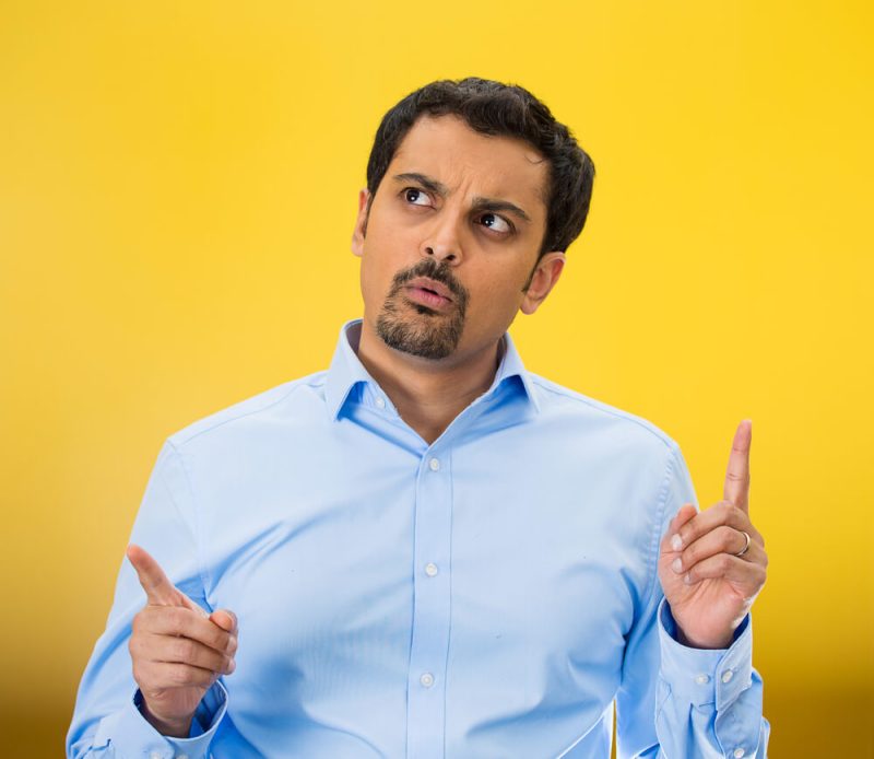 Man with yellow background trying to decide if he should switch car insurance companies - cheap car insurance in Washington.