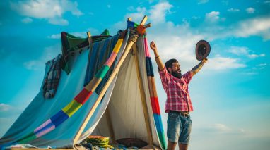 Man celebrates outside of his tent - cheap home insurance in Washington.