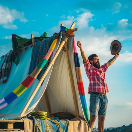 Man celebrates outside of his tent - cheap home insurance in Washington.