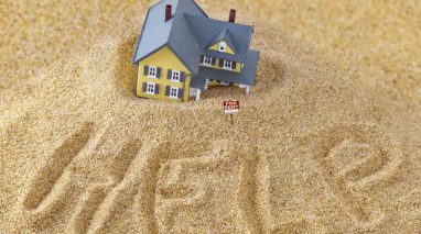 Place house sinking into sand with the words help in the sand and for rent sign - cheap home insurance in Seattle.