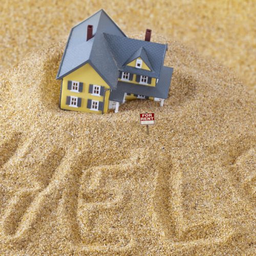Place house sinking into sand with the words help in the sand and for rent sign - cheap home insurance in Seattle.