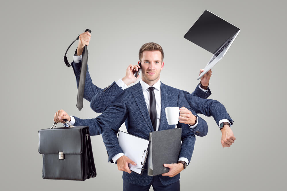 Businessman juggling multiple things but smiling because his company is protected with business insurance - cheap business insurance in Seattle.